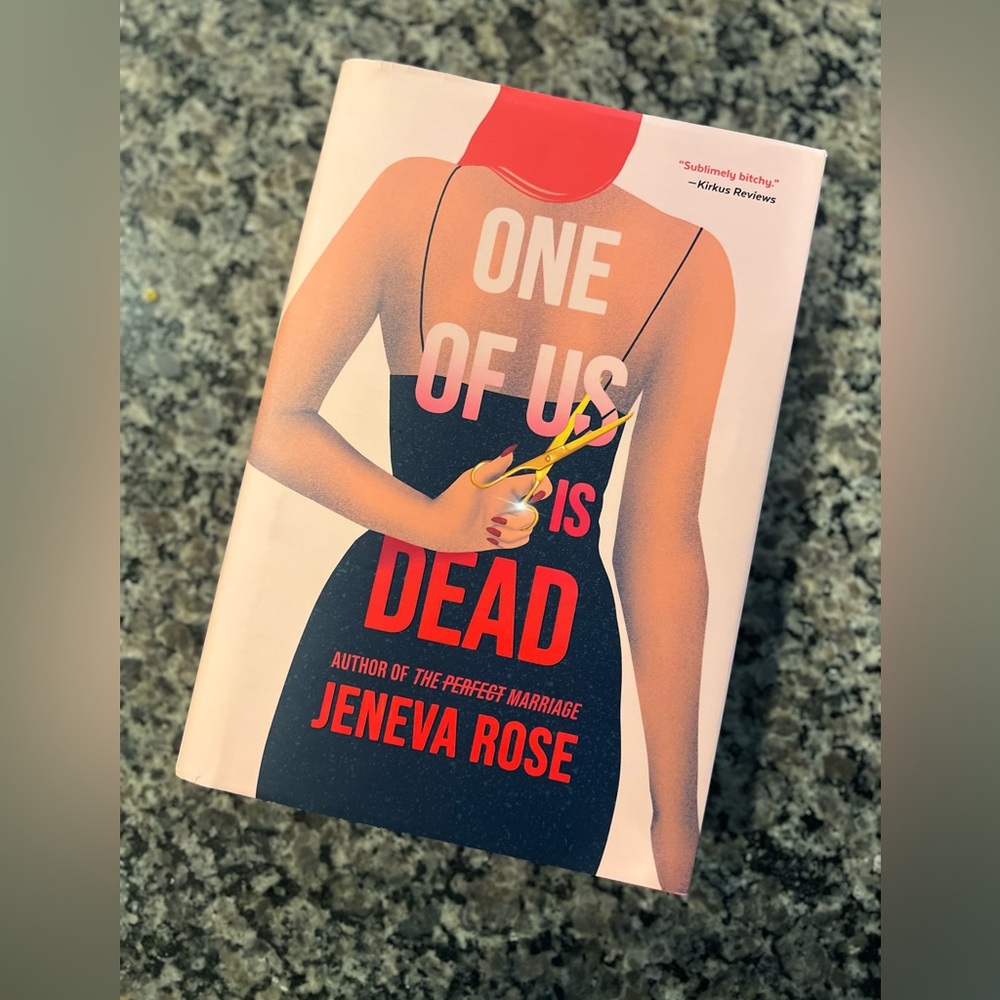 Hardback book “One of us is Dead” by Jeneva Rose